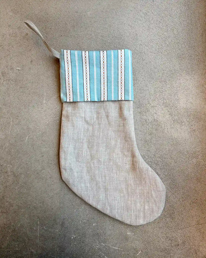 En beige julstrumpa med blå kant