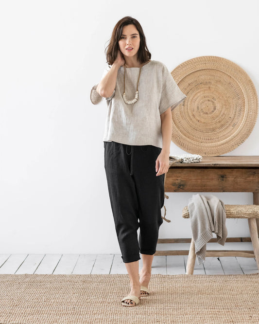 Svarta linnebyxor och en beige linneblus
