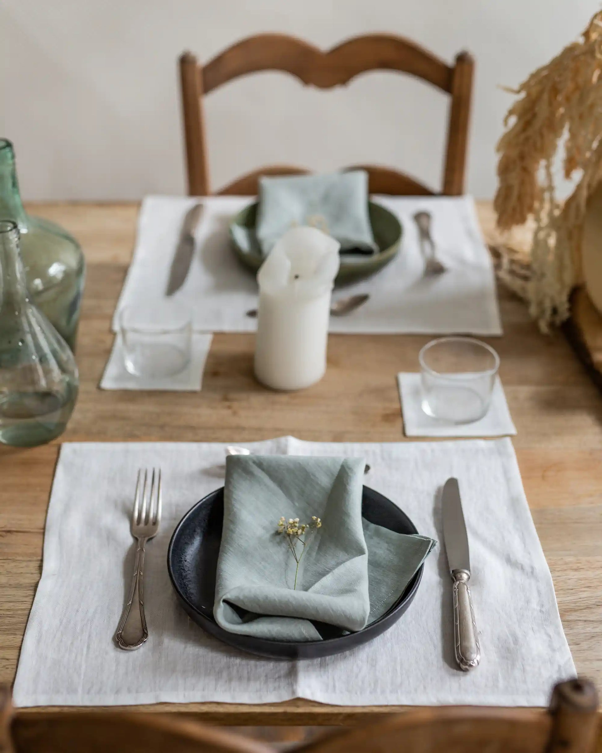 Ett dukat bord med handsydda linnetextilier.